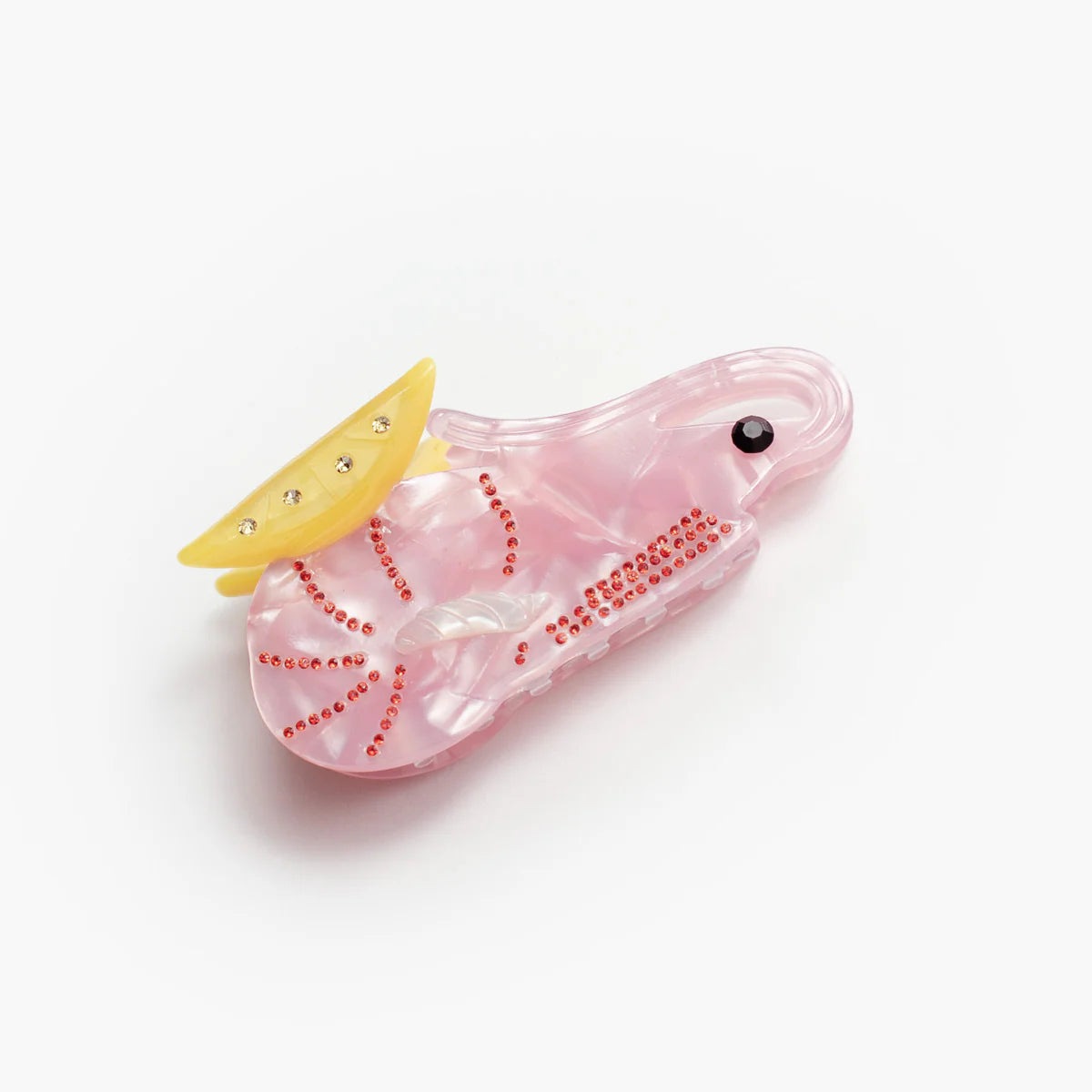 Kolorowa klamra do włosów Cajun Shrimp Claw w kształcie krewetki marki Winona Irene sfotografowana na jasnym tle.